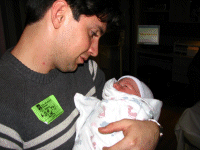 Daddy holding his son for the first time